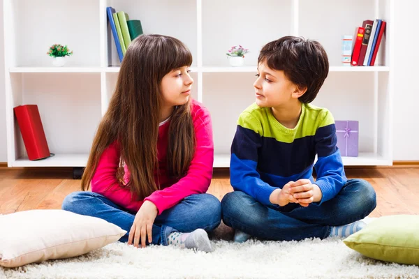 Girl and boy on carpet