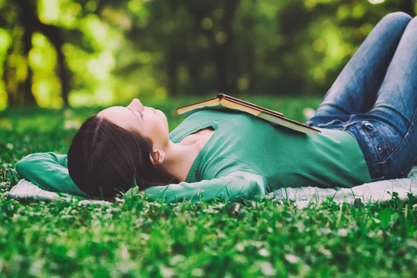 Woman lying down in nature and sleeping