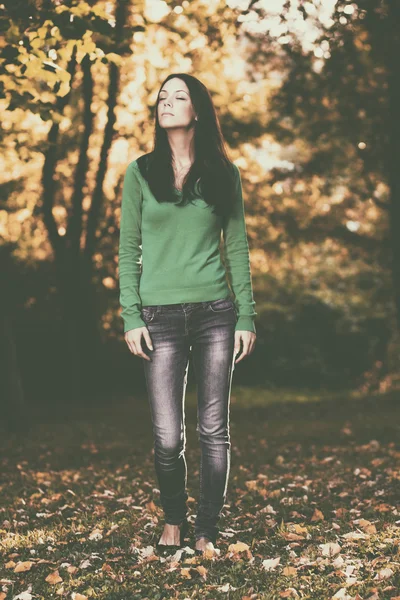 Woman enjoys walking through the forest