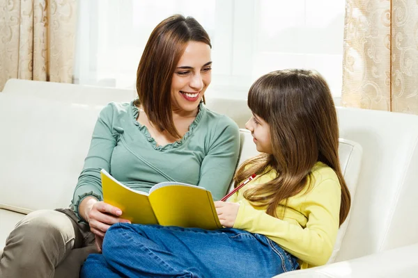 Mother helps daughter with her homework