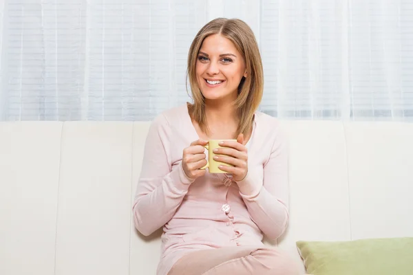 Happy woman with cup of tea
