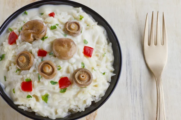 Saffron Milk Cap mushroom rice on a bowl on wooden background