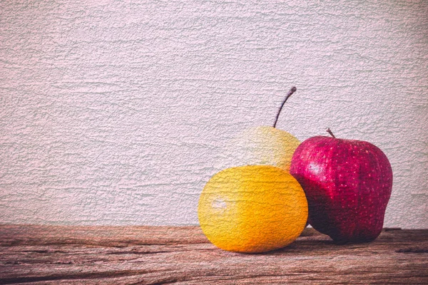 Abstract Apple and Pear with orange on cement textured filtered