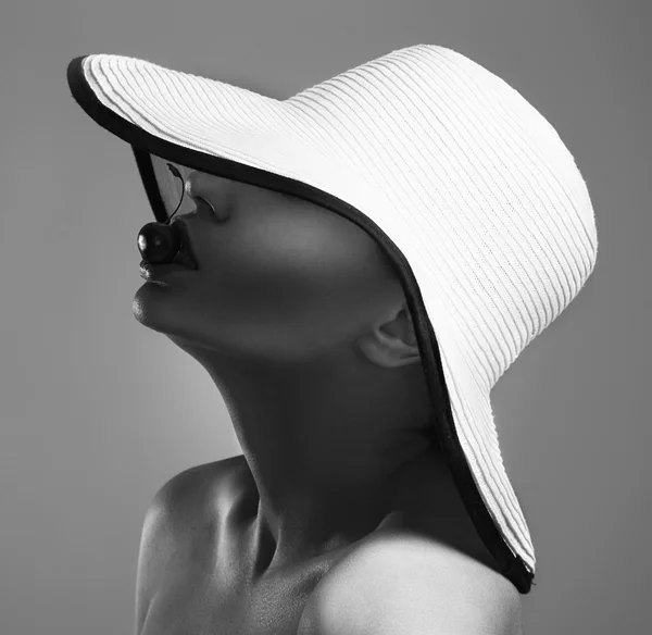 Beauty Woman face Portrait in a white hat. Beautiful model Girl