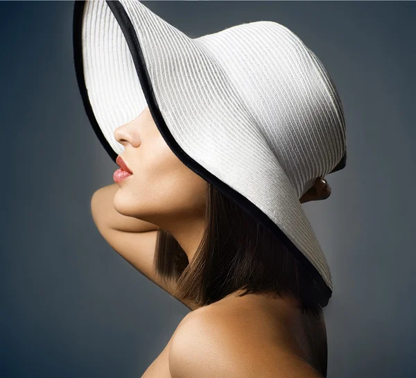 Beauty Woman face Portrait in a white hat. Beautiful model Girl