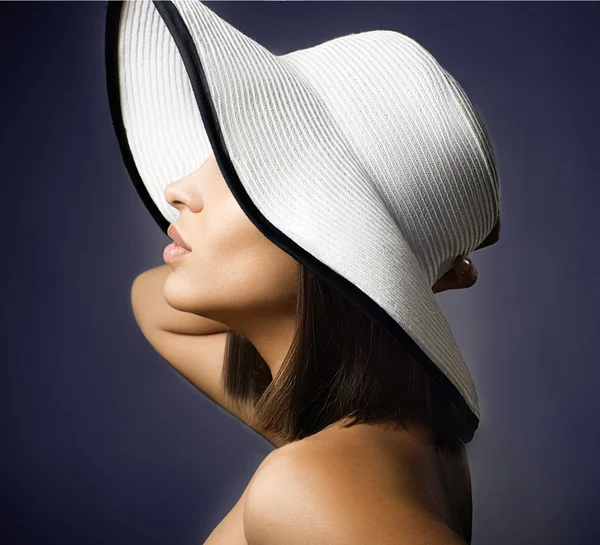 Beauty Woman face Portrait in a white hat. Beautiful model Girl