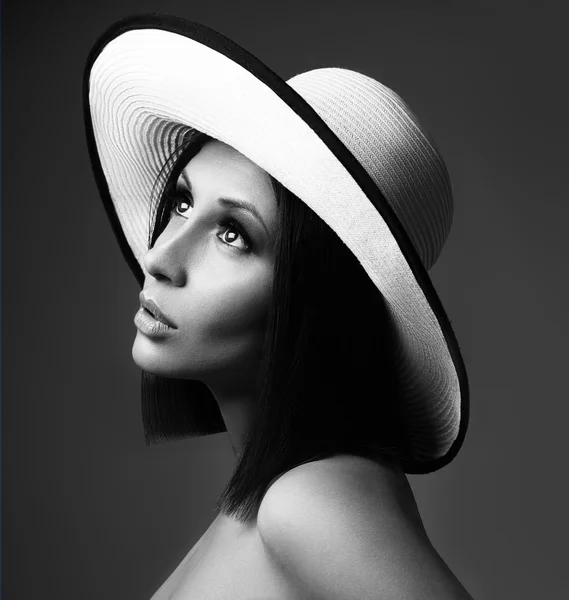 Beauty Woman face Portrait in a white hat. Beautiful model Girl