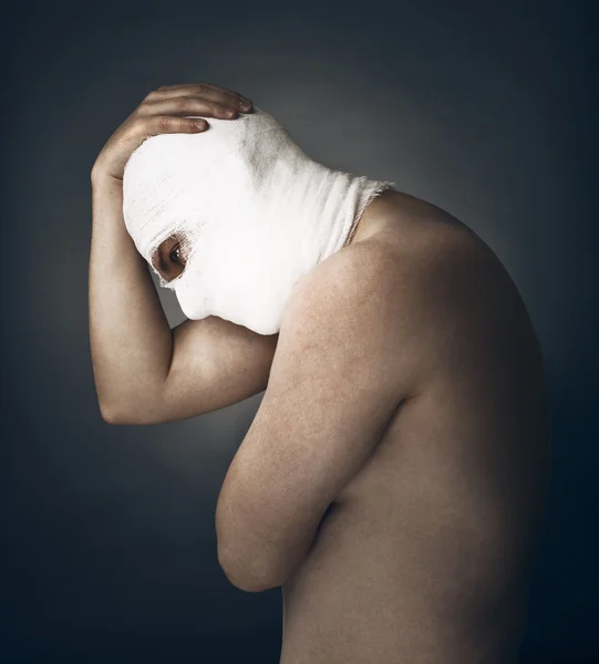 Head tied up by bandage . Conceptual photo