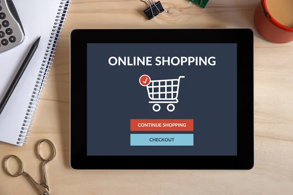 Online shopping concept on tablet screen with office objects