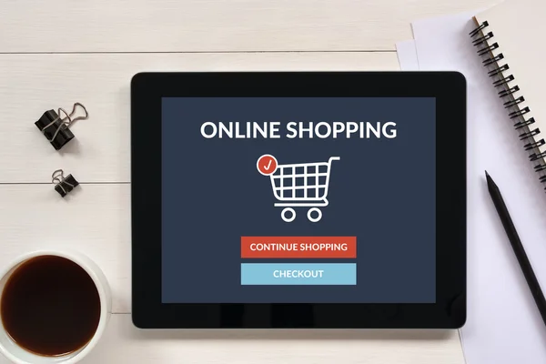 Online shopping concept on tablet screen with office objects