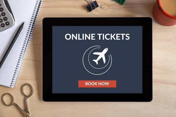 Online tickets concept on tablet screen with office objects