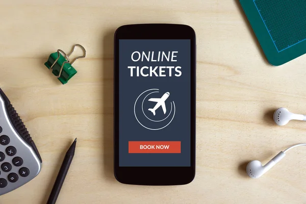 Online tickets concept on smart phone screen on wooden desk