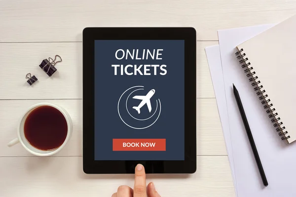 Online tickets concept on tablet screen with office objects