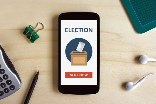 Online voting concept on smart phone screen on wooden desk