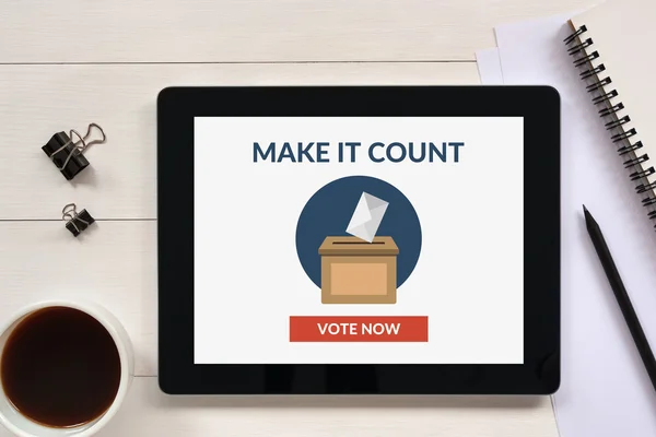 Online voting concept on tablet screen with office objects