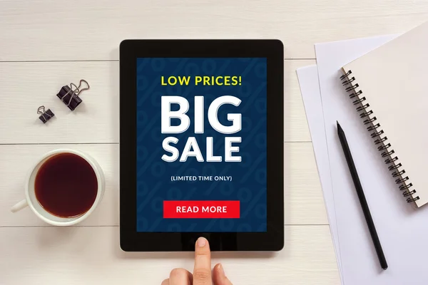 Big sale concept on tablet screen with office objects