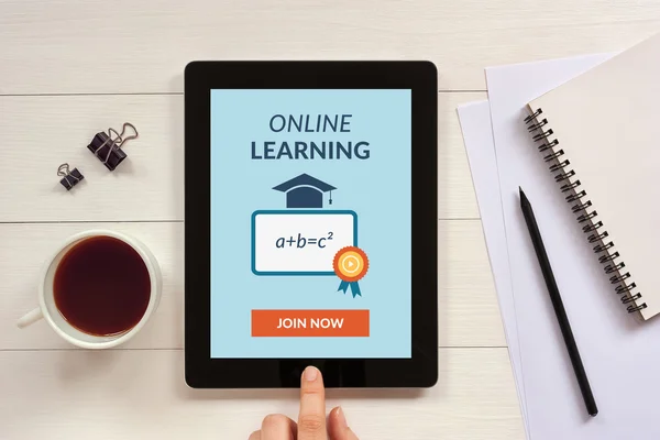 Online learning concept on tablet screen with office objects
