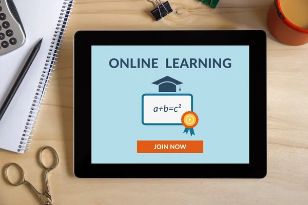 Online learning concept on tablet screen with office objects