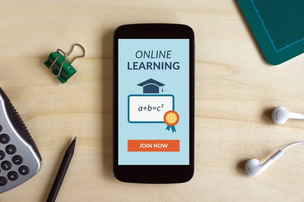 Online learning concept on smart phone screen on wooden desk