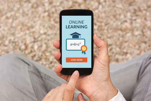 Hands holding smart phone with online learning concept on screen