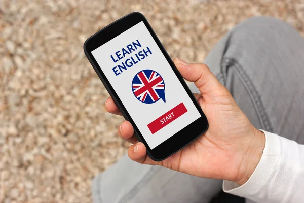 Hand holding smartphone with online learn English concept on scr