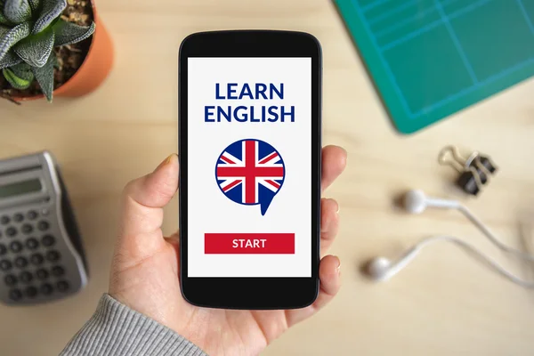 Hand holding smartphone with online learn English concept on scr