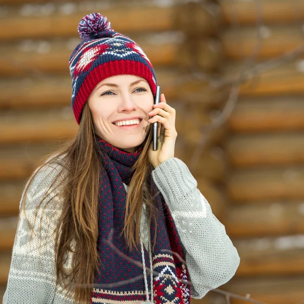 Winter young woman talking on mobile phone