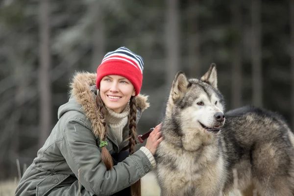 Woman with dog. Alaskan malamute