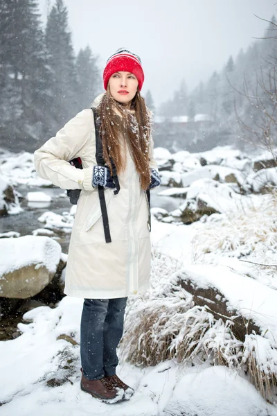 Portrait of adventure woman  in snowy mountains