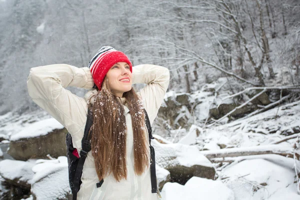 Portrait of adventure woman in winter mountain river