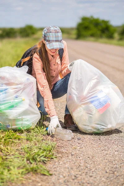 Woman picking up trash