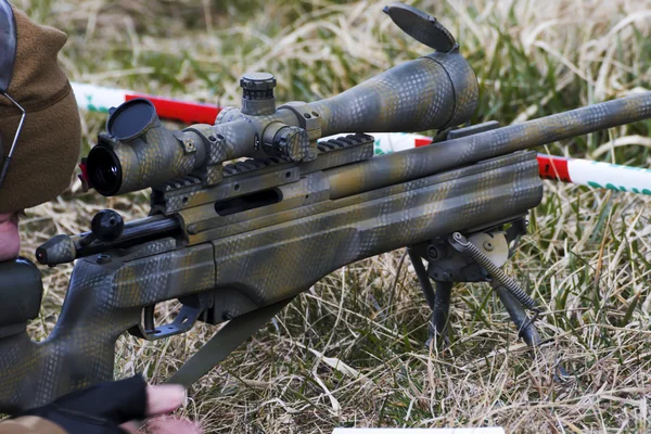 Military sniper aims at a target