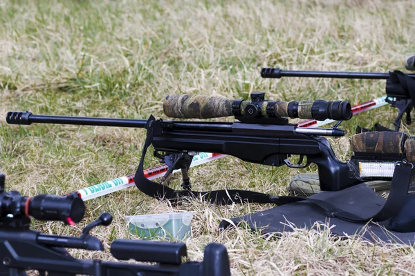 Military sniper aims at a target