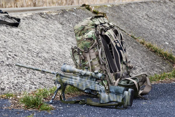 Military sniper aims at a target