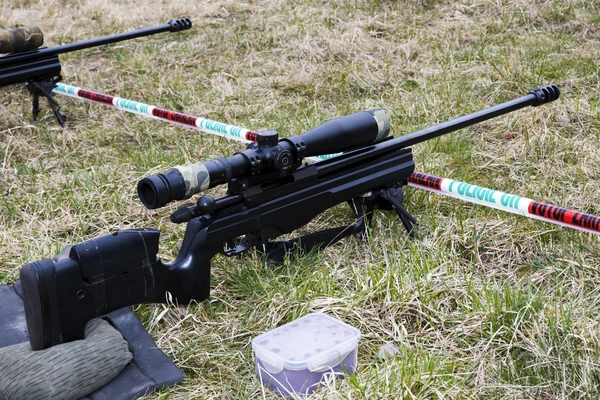 Military sniper aims at a target