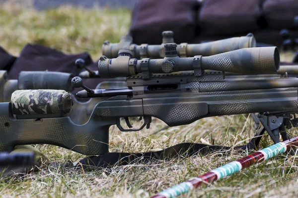 Military sniper aims at a target