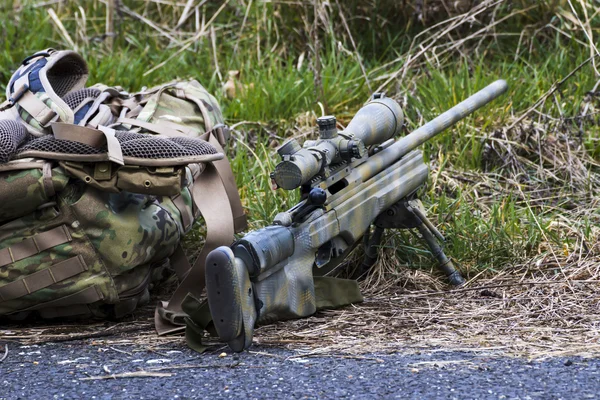 Military sniper aims at a target