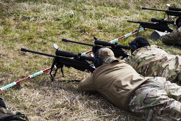 Military sniper aims at a target