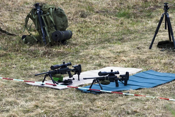 Military sniper aims at a target