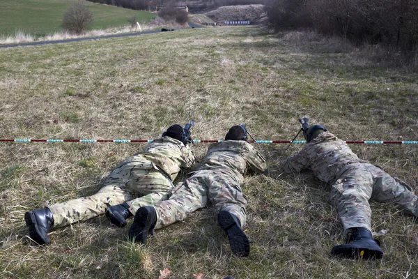 Military sniper aims at a target