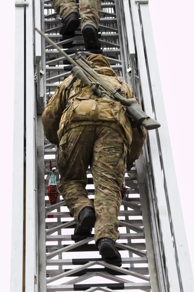 Military sniper aims at a target