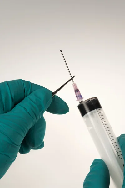 Syringe with the needle on a white background