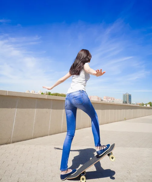 Woman skateboard, full height, back, riding