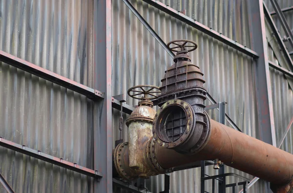 The flanges and old metal constructions in industrial zone