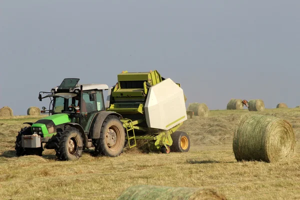 Tractor collecting haystack