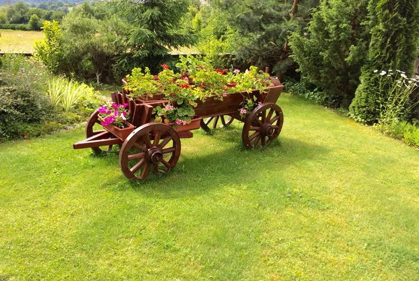 Flower bed on old wooden cart