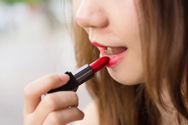 Part of attractive woman\'s face with fashion red lips makeup. Ma