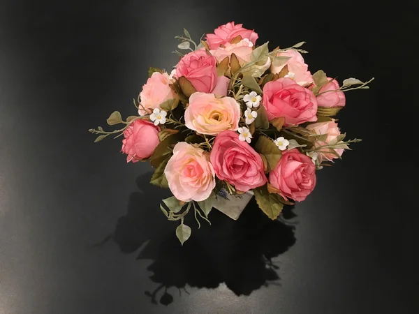 Rose flower in version Artificial Flowers bouquet in vase on bla