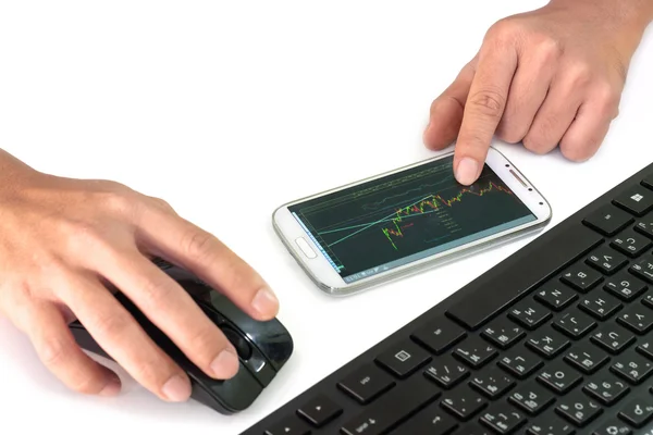 Businessman using a mobile device to check stocks and market dat