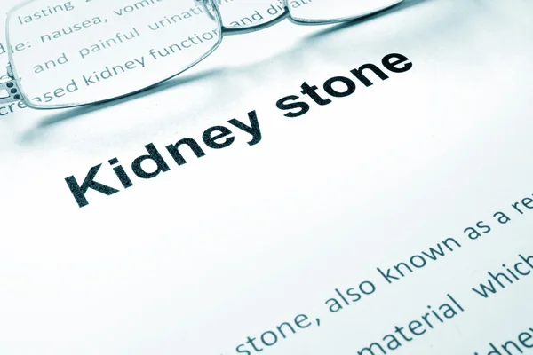 Kidney stone sign on a paper and glasses.